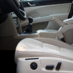 Driver installing a custom-fit car seat cover in their vehicle