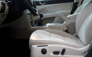 Driver installing a custom-fit car seat cover in their vehicle