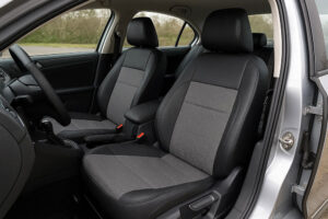 Hands installing a car seat covers set on a modern car interior