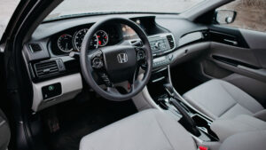 Trim-specific Honda Accord seat protector with perforated center panel and airbag-safe side stitching installed on driver seat