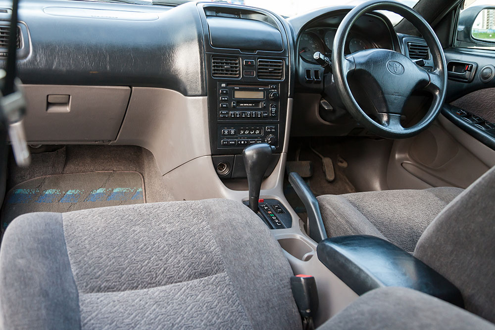 Close-up of custom Toyota seat covers in a family SUV with two-tone stitching