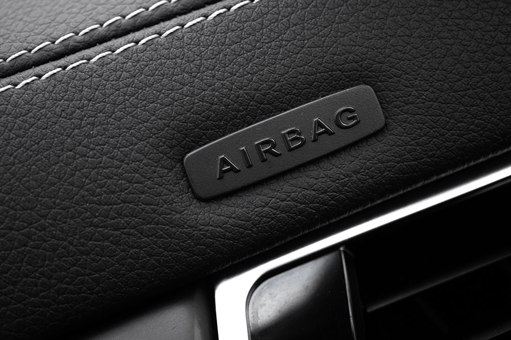 Custom car seat covers with airbag-compatible side stitching installed in a modern vehicle interior